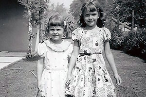 Gail (4) and Carol Ann (7) near the front porch of their home, 1955.